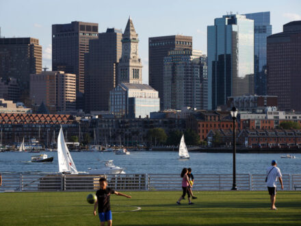 JF5H7A People on soccer football field on the East Boston waterfront, skyline Boston Harbor